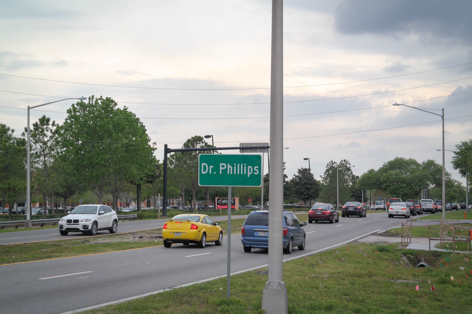 Dr. Phillips roadside sign and neighborhood traffic in Florida